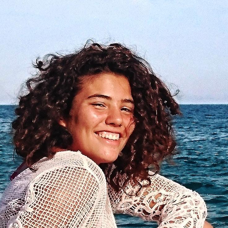 Kaveri Mehta, Lead Design Curator at MossAndMarble, reviewing corporate floral arrangements